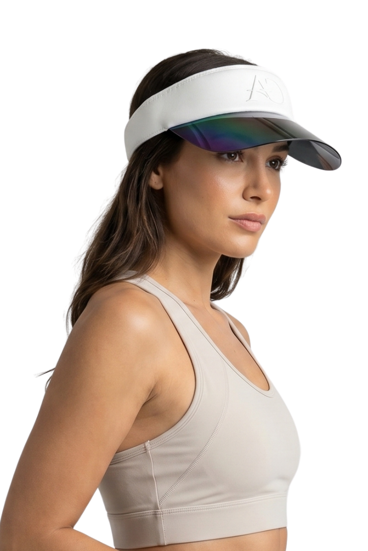 Woman wearing a beige sports bra and visor on a white background